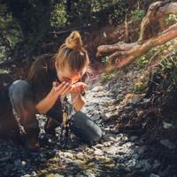 Woman washing face in river